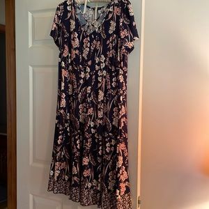 Women’s dress in a pretty black background with beige and cream colored flowers